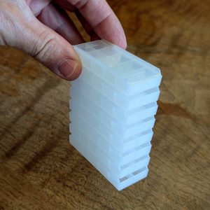 Trays stacked with lids supported