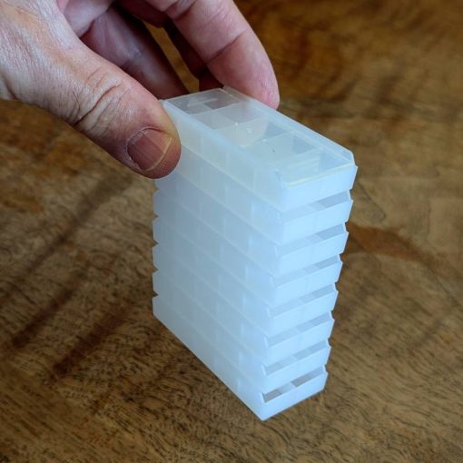 Trays stacked with lids supported